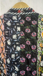 Load image into Gallery viewer, Black boho quilted jacket close-up highlighting traditional hand-printed textiles and artisan craftsmanship
