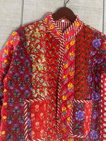 Load image into Gallery viewer, Close-up detail of quilted patchwork jacket showing handcrafted kantha embroidery and colorful fabric patches
