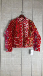 Load image into Gallery viewer, Reversible cotton patchwork jacket laid flat showing unique handcrafted design and contrasting trim details
